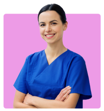 Smiling woman wearing blue medical scrubs standing with arms crossed in front of a bright pink background.