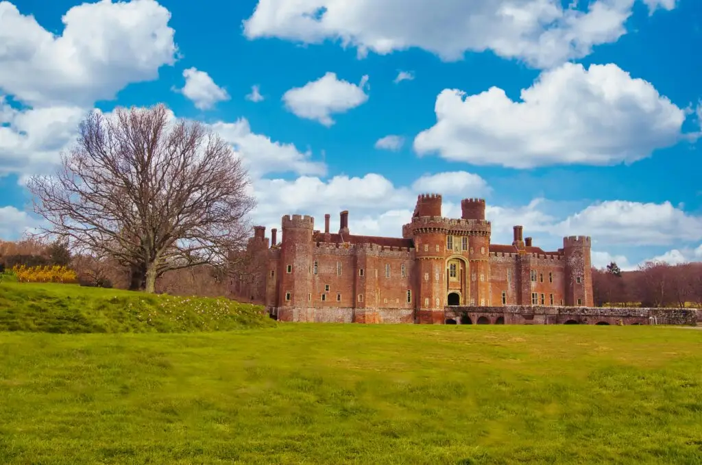 Kenilworth Castle surrounded by green parkland under a blue sky